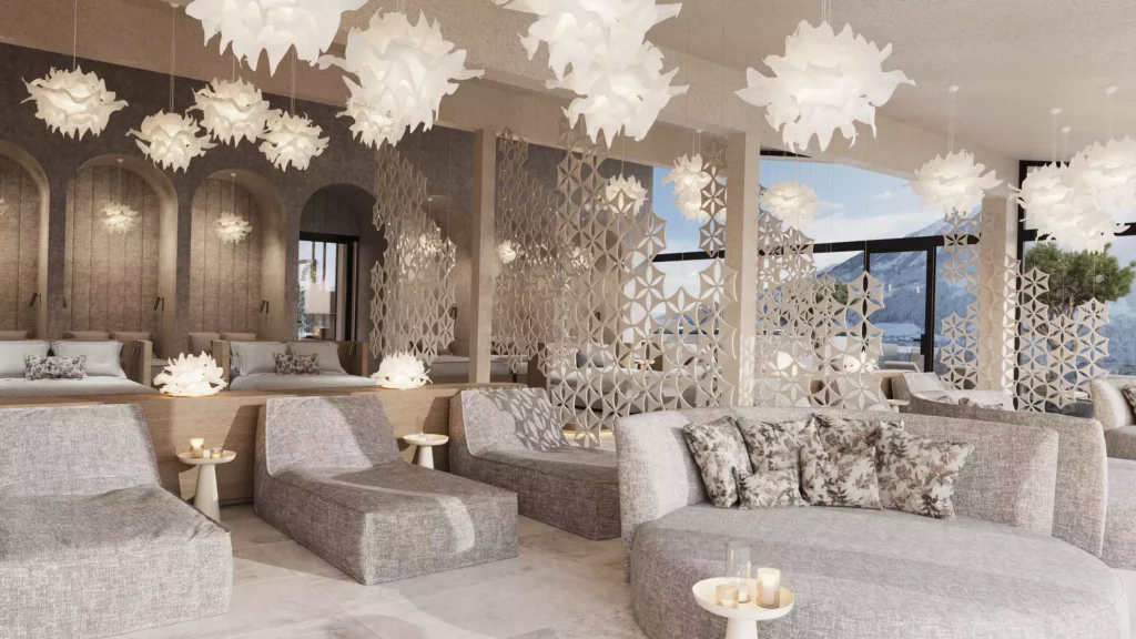 Hotel Berghof_09 Modern eingerichteter Lounge-Bereich im Hotel Berghof mit bequemen Sitzmöbeln und dekorativen Hängelampen vor Bergpanorama