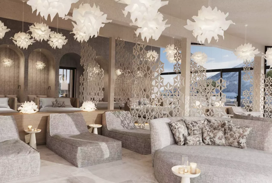 Modern eingerichteter Lounge-Bereich im Hotel Berghof mit bequemen Sitzmöbeln und dekorativen Hängelampen vor Bergpanorama