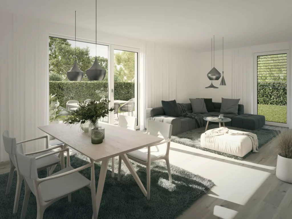 deutinger-projektentwicklung-baumanagement-generalunternehmen-immobilien-salzburg-projekt-wohn-traum bluntaustrasse-golling-04-neu Helles modernes Wohn- und Esszimmer mit großem Esstisch, grauer Couch, Teppichen und Blick auf Garten durch große Fenster.