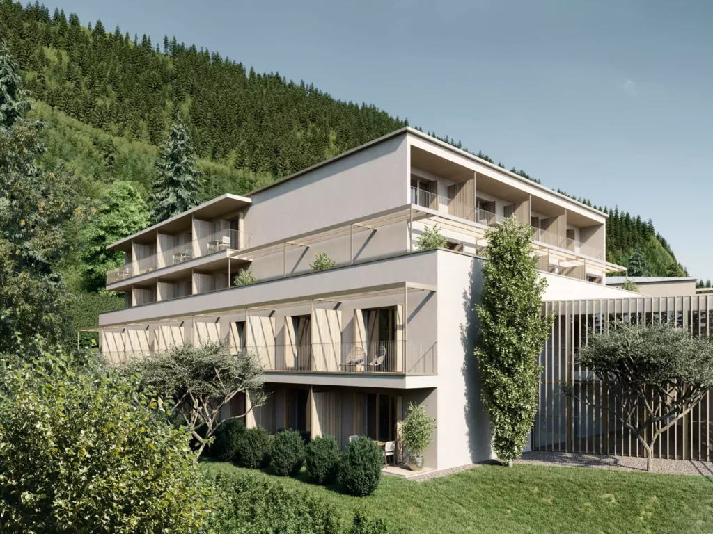 Wohnpark_Gastein (4) Moderner Wohnpark Gastein mit Balkonen und Terrasse, umgeben von grünen Bäumen und Bergen im Hintergrund