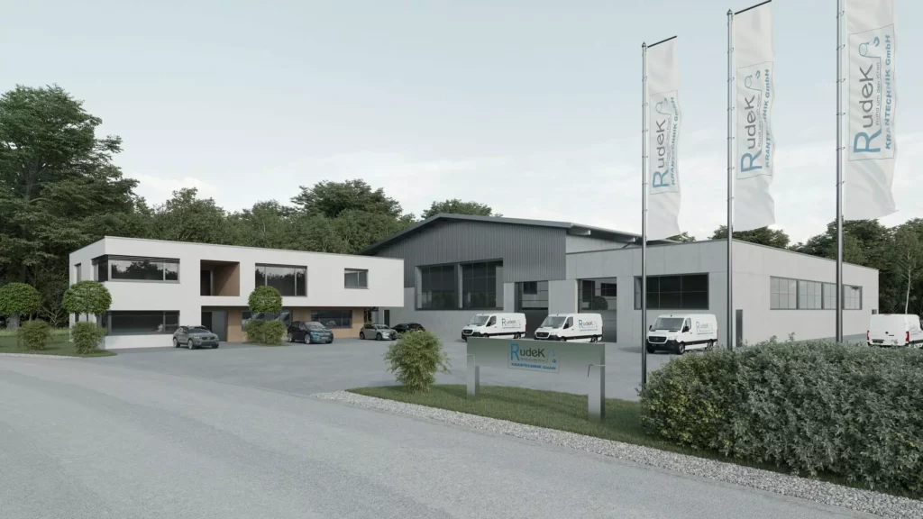 deutinger-projektentwicklung-baumanagement-generalunternehmen-immobilien-salzburg-projekt-betriebshalle-rudek-01 Moderne Betriebshalle mit Bürogebäude, Firmenfahrzeugen und Fahnen der Rudek Krantechnik GmbH in Salzburg