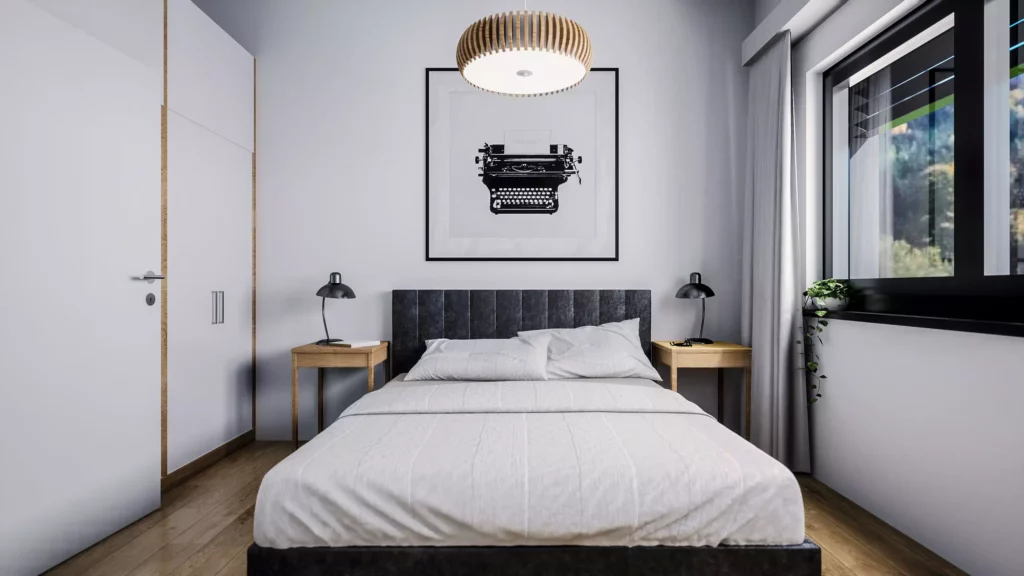 deutinger-projektentwicklung-baumanagement-generalunternehmen-immobilien-salzburg-projekt-mountainview-alpendorf-Schlafzimmer-Top-5 Modernes Schlafzimmer mit Doppelbett, zwei Nachttischen, Lampen, großem Fenster und Bild mit Schreibmaschine an der Wand