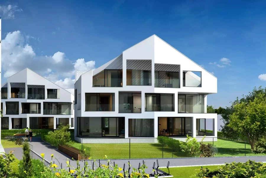 Moderne Wohngebäude mit großen Fenstern und Gärten im Wohnpark Fischergasse Salzburg bei klarem Himmel